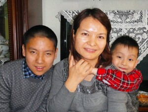Gulinuer Yimiti, the wife of the Uyghur Christian Alimujiang Yimiti, and her two sons. 