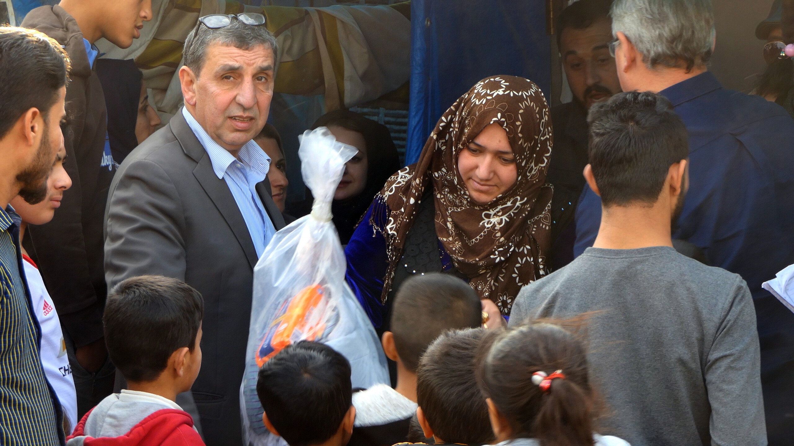 Release partner Jamal left and Paul Robinson distribute aid at a refugee camp in Erbil 2. Picture by Andrew Boyd scaled