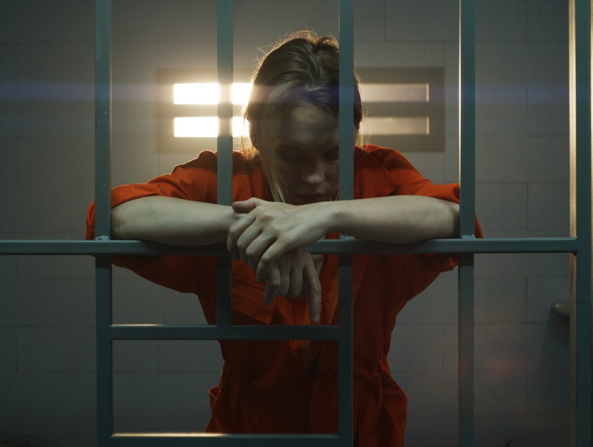 Female Prisoner Behind Bars